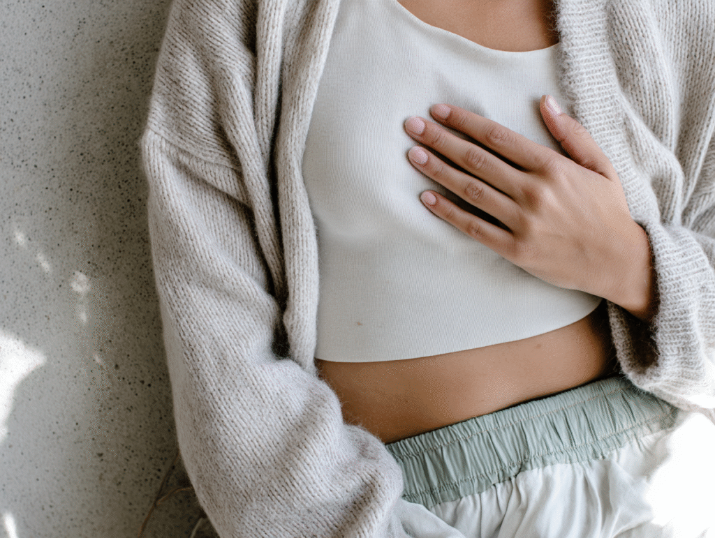 a woman holds a hand to her heart